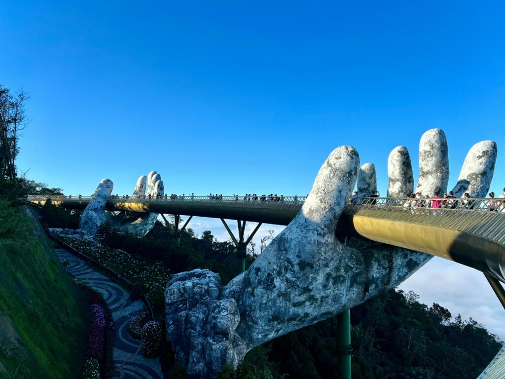 Hands holding the golden bridge in Vietnam